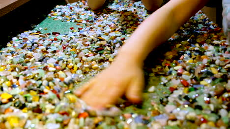 Kids-rummage-through-wide-selection-of-colorful-gemstones-with-their-hands