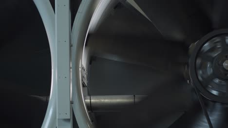 Turbine-fan-spinning-inside-factory-to-ventilate-system,-close-up