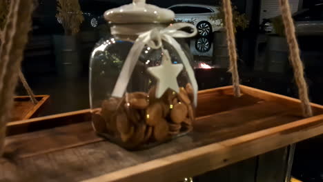 Jar-of-miniature-cookies-on-a-rustic-swing-shelf-hanging-outdoor
