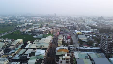 A-dense-urban-landscape-with-buildings,-haze,-and-daylight