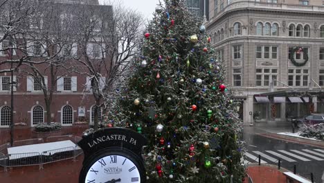 Lancaster,-PA-clock-and-Christmas-tree-in-downtown-square-during-snow-flurries