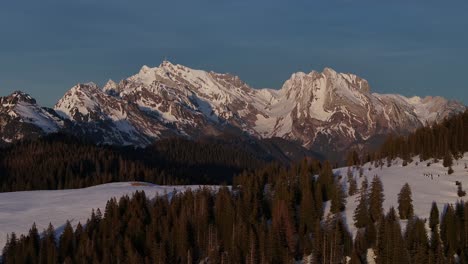 Crisp-light-on-Amden's-mountain-tops-at-dawn,-Switzerland---aerial