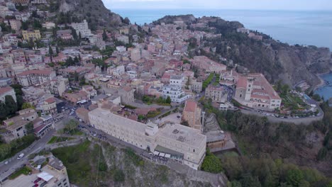 Aerial-orbit-over-Taormina,-Sicily,-Italy-a-south-side-of-the-city-on-the-volcano