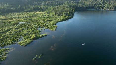 Drone-shot-of-a-small-fishing-boat-on-a-Spirit-Lake,-Idaho