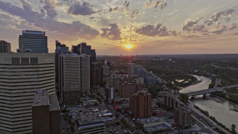 Calgary-AB-Canada-Aerial-v49-reverse-flyover-East-Village-capturing-urban-cityscape-of-Eau-Claire,-Chinatown-and-Downtown-with-beautiful-summer-sunset-skyline---Shot-with-Mavic-3-Pro-Cine---July-2023