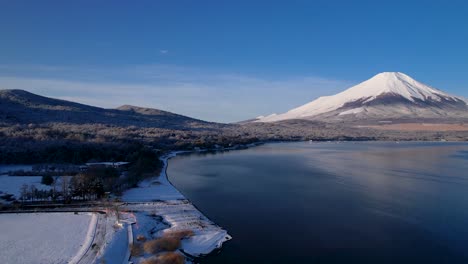 Winter-Time-In-Japan-With-Mt-Fuji-and-Forest-Covered-In-Snow-Next-To-Lake