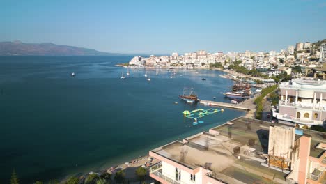 Cinematic-Drone-Shot-Reveals-Saranda-Bay-on-Beautiful-Summer-Day-in-Albania