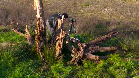 Aerial-View-of-A-Male-Photographer-Checking-Out-His-Shot-On-Camera-In-Tripod