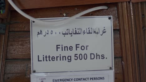 Fine-For-Littering-500-Dirhams,-Warning-Sign-Board-on-Boat-in-UAE,-Close-Up