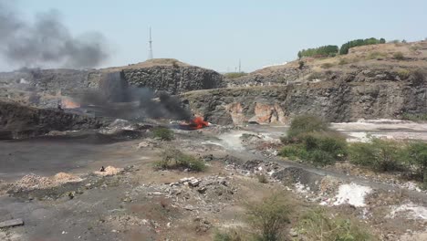 Establishing-Shots-drone-camera-Burning-plastic-waste-and-looking-around-Dumping-yard-is-visible