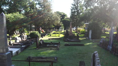 Drone-flying-closely-between-gravestones-and-tombs-in-a-cemetery-on-a-sunny-day-in-Australia