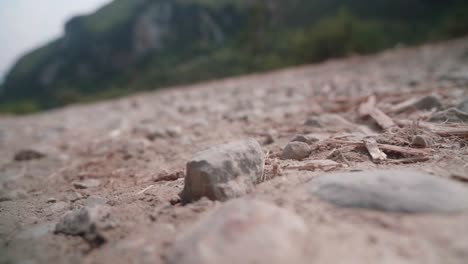 detail-of-a-trekking-boot-treading-on-rocky-terrain