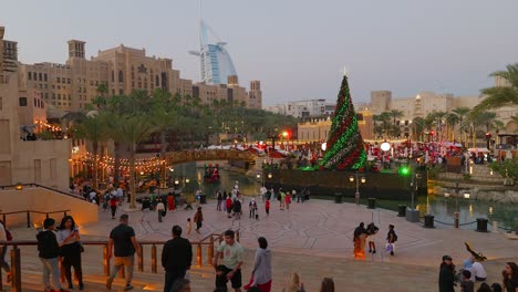 Dubai,-UAE---December-26,-2023:-Christmas-tree-and-burj-al-arab-view-in-Souk-Madinat-Jumeirah-in-Dubai