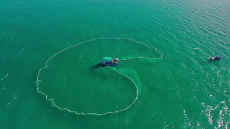 Drone-view-netting-anchovies-on-Hon-Yen-sea,-Phu-Yen-province,-central-Vietnam