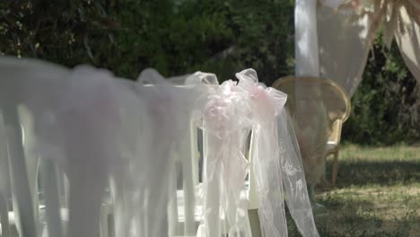 Slow-revealing-shot-of-decorated-chairs-ready-for-an-exterior-wedding-reception
