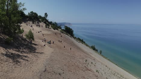 Sleeping-Bear-Sand-Dunes-National-Lakeshore-overlook-of-Lake-Michigan-in-Michigan-with-people-on-dunes-and-video-panning-left-to-right