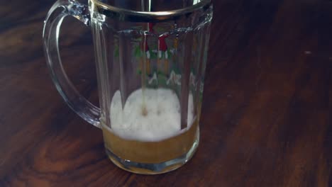 Narrow-focus-closeup:-Refreshing-beer-is-poured-into-large-beer-glass
