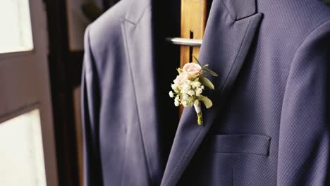 decorative-flower-bouquet-hanging-from-a-wedding-groom's-blazer