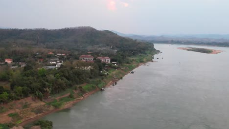Picturesque-aerial-scenery-of-the-Mekong-River-and-Chiang-Khan-district-with-silhouette-of-hills-on-a-misty-morning-in-Thailand