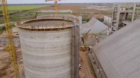 Expansive-silo-construction-site-at-dawn---aerial-view-reveal