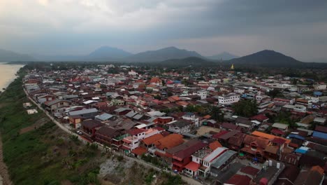 Aerial-scenery-of-Chiang-Khan-District-alongside-the-Mekong-River-in-Thailand,-drone-fly-forward