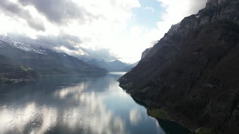 Aerial-Shot-Of-Rocky-Mountains-And-Clouds-On-Walensee-Unterterzen-Lake-Surface-In-Switzerland