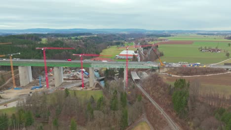 Industrial-Crane-Towering-On-Highway-Bridge-Construction-Site