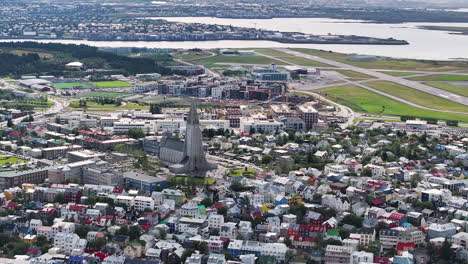 Aerial-View-of-Downtown-Reykjavik,-Iceland,-Hallgrimskirkja-Church-and-Central-Buildings-on-Sunny-Summer-Day
