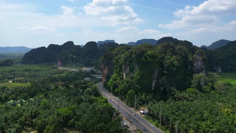 Tropical-landscape-karst-mountains-road-palm-trees