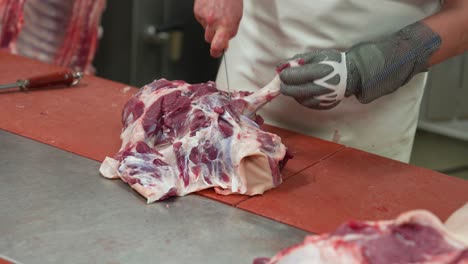 Removing-bones-of-pig-carcass-in-slaughterhouse-abattoir-butchery