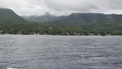 Wide-shot-of-scenic-landscape-in-the-Philippines,-while-crossing-the-river-on-a-boat