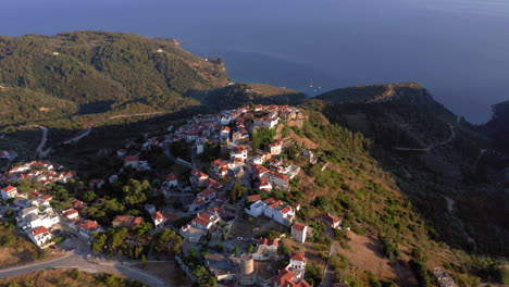 Aerial:-Panoramic-drone-view-over-the-beautiful-old-Village-of-Alonnisos-island-in-Sporades,-Greece-during-sunset