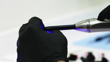 Closeup-of-Dentist-using-Ultraviolet-Light-to-Glue-Prototype