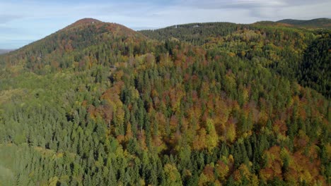 Aerial-orbit-over-the-unhabituated-rural-landscape-with-autumn-mountain-forest-during-the-fall-season