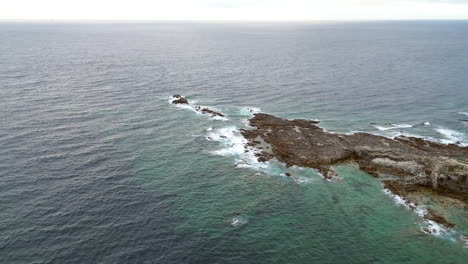 Aerial-Pan-View-of-the-Ocean-and-Coastline-with-Small-Town