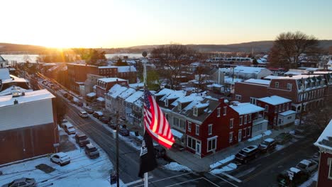 American-flag-waving-in-USA-town-during-winter-sunset