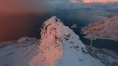 FPV-Drone-dive-down-a-mountain-during-sunset-in-Lofoten,-Norway