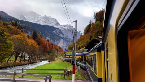 Swiss-Alps-train-ride-Grindelwalk-Jungfrau-Interlaken-to-Lauterbrunnen-Switzerland-late-October-November-autumn-fall-colors-river-late-afternoon-Bernese-Overland-Thun-Bern-region-snow-peak-glacier