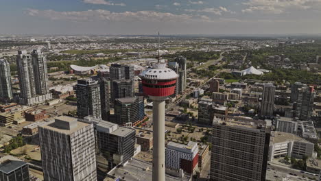 Calgary-AB-Canada-Aerial-v22-drone-fly-away-from-landmark-observation-tower,-reveals-cityscape-of-Downtown-Commercial-and-Beltline-districts-on-a-sunny-day---Shot-with-Mavic-3-Pro-Cine---July-2023