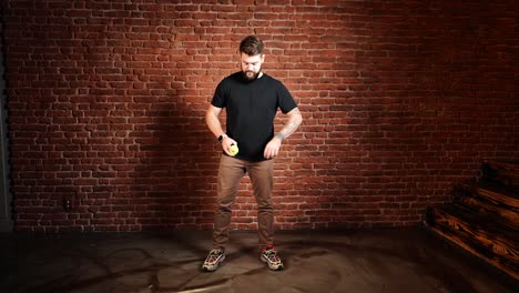 Male-change-standing-position-and-continue-to-throw-and-catch-tennis-ball