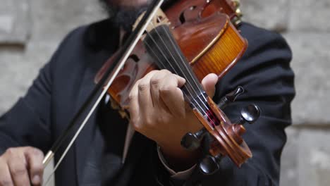 Bearded-man-playing-a-viola-with-double-strings,-close-up