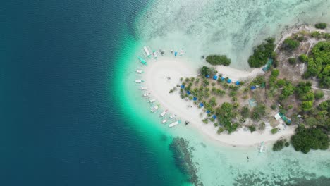 Coloridos-Barcos-Turísticos-Amarrados-Alrededor-Del-Banco-De-Arena-De-Pass-Island-En-Coron,-Aéreo