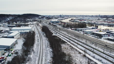 Snow-covered-European-route-E45-just-outside-Gothenburg,-aerial-view-of-winter-traffic