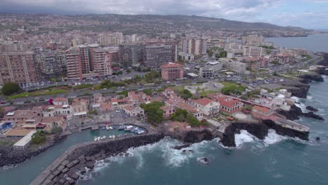Aerial-trucking-shot-of-the-waterfront-of-Catania,-Sicily,-Italy