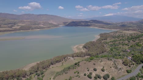 Aerial-establishing-shot-of-the-drying-lake-of-Pozzillo-near-Regalbuto-on-the-Erei-mountains-with-Etna-volcano---drought-problem-in-Italy