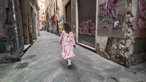 Handheld-clip-showing-an-artistic-woman-walking-throat-city-streets-with-street-art-and-graffiti