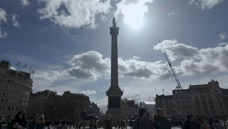 Nelson's-Column-Against-Sunny-Sky-In-Crowded-Trafalgar-Square,-Westminster,-London,-UK