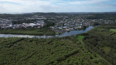 Industrial-Buildings-And-Houses-With-Vegetation-Along-Currumbin-Creek-In-Queensland,-Australia
