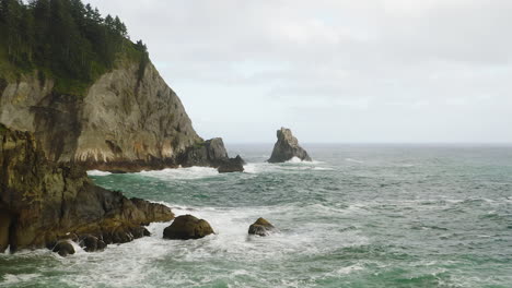 Small-sea-stack-protruding-from-turbulent-Pacific-Ocean-off-rocky-Oregon-Coast