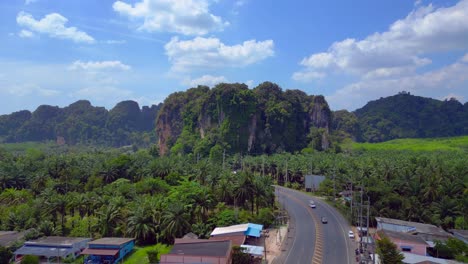 Tropical-landscape-karst-mountains-road-palm-trees